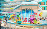 A rendering of the carousel in Icon of the Seas’ Surfside neighborhood, with the Surfside accommodations towering above.