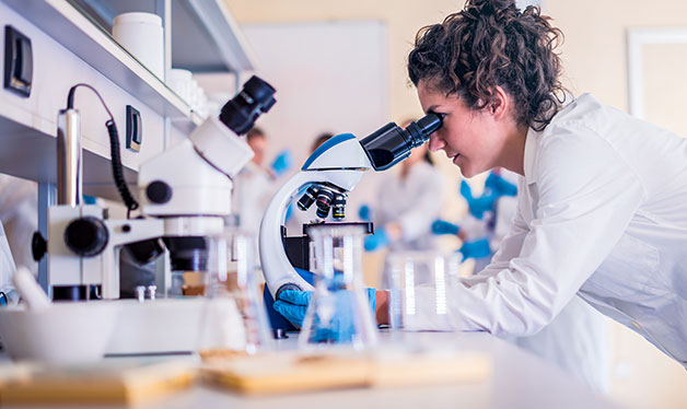 woman using a microscope