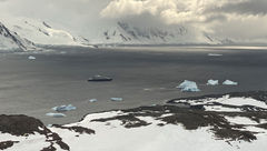 Viewed from a helicopter, the Scenic Eclipse cruise ship looks small against Antarctica's grandeur.