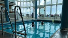 Two guests enjoying a swim at the Seahorse Pool in the Solarium.