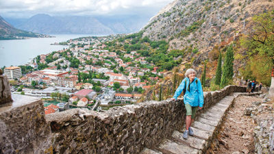A woman in Kotor, Montenegro, travels solo with Overseas Adventure Travel, which primarily caters to travelers over age 50.